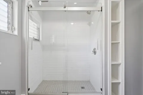 a bathroom with a glass shower door