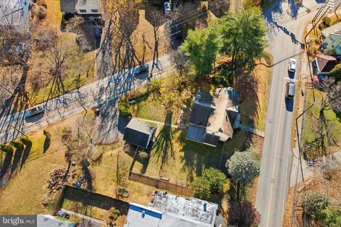 an aerial view of a house with a yard and parking space
