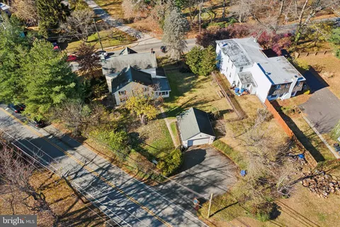 an aerial view of residential house with parking
