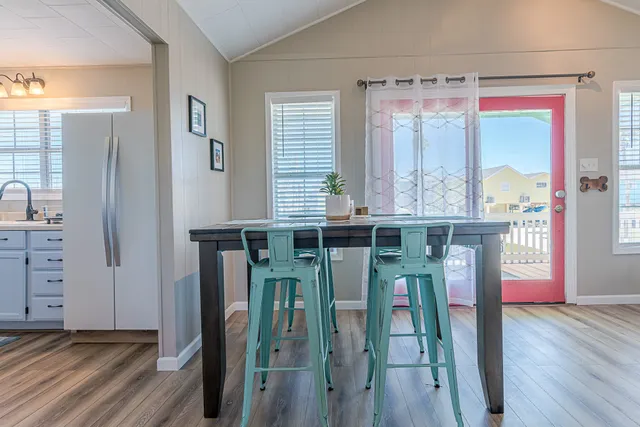 a living room with furniture dining table and a large window