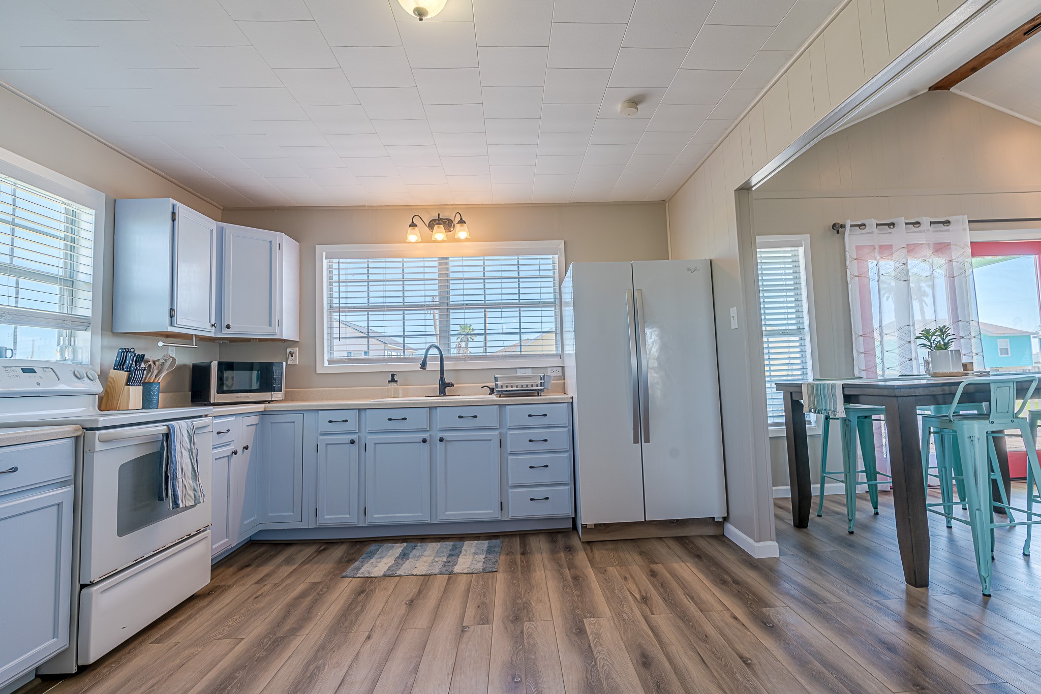 402 Seashell Drive Surfside Beach, TX 77541 - Photo 11 of 35 a kitchen with cabinets and wooden floor