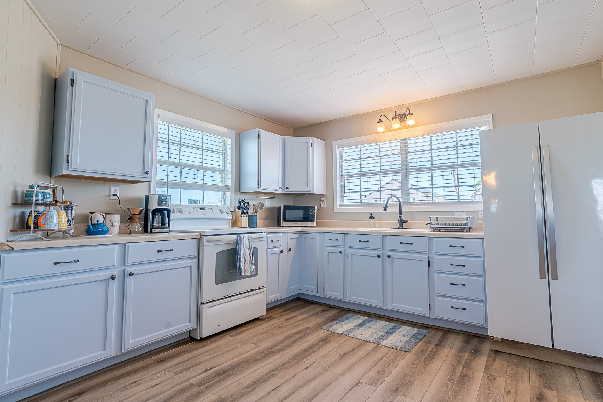 402 Seashell Drive Surfside Beach, TX 77541 - Photo 13 of 35 a kitchen with cabinets stainless steel appliances a sink and a window