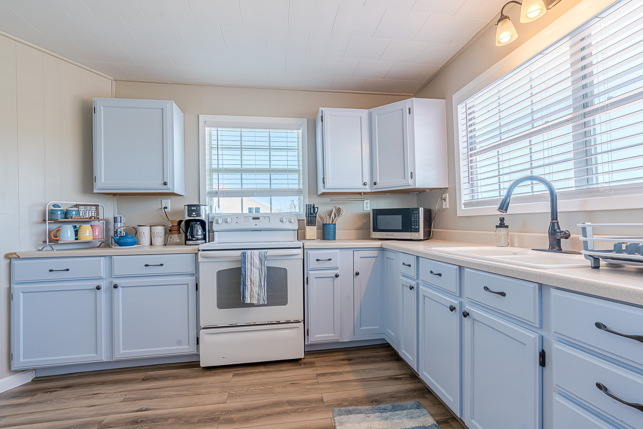 402 Seashell Drive Surfside Beach, TX 77541 - Photo 14 of 35 a kitchen with cabinets appliances a sink and a window