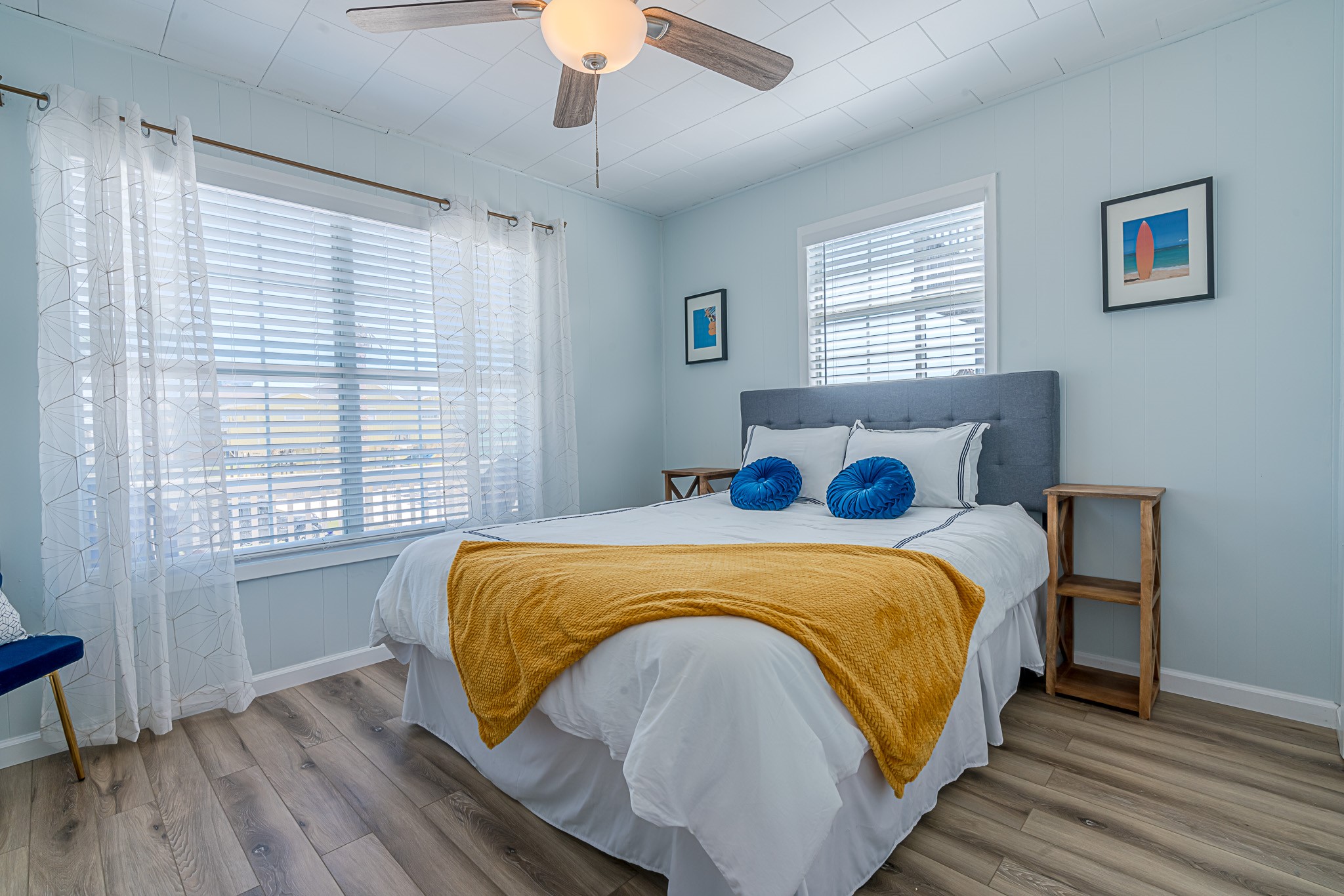 402 Seashell Drive Surfside Beach, TX 77541 - Photo 15 of 35 a bedroom with a bed and wooden floor
