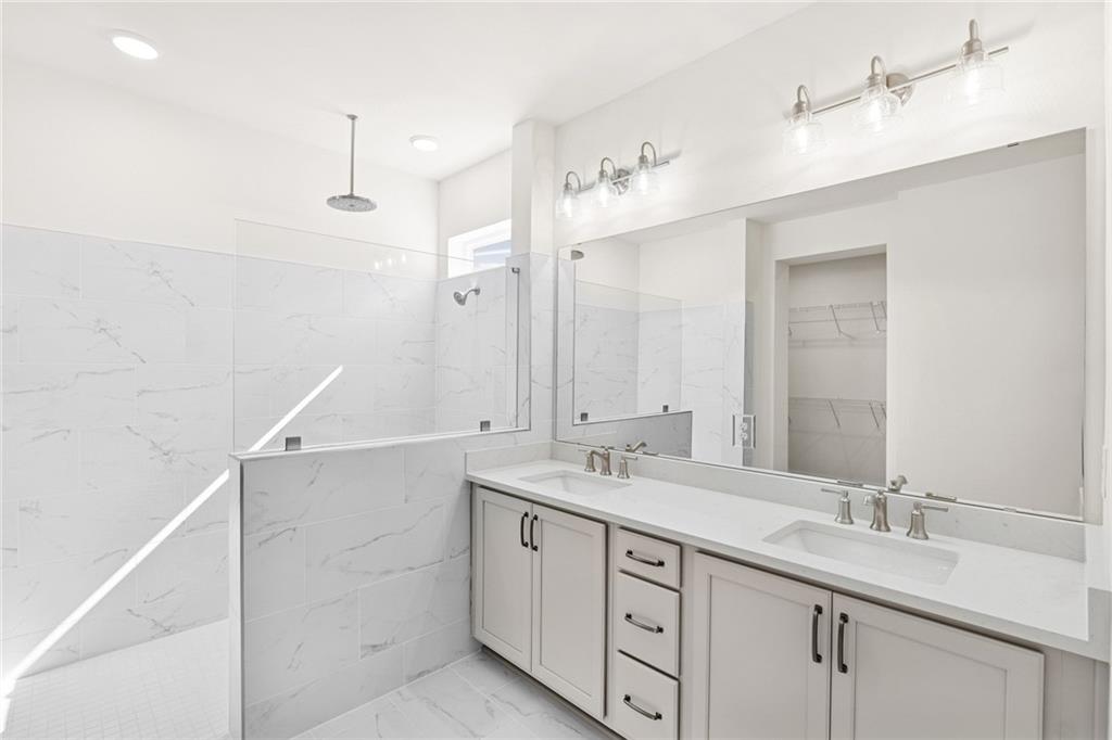 580 Barnfield Way Hiram, GA 30141 - Photo 12 of 12 a bathroom with a double vanity sink and mirror