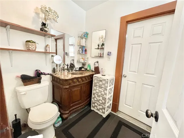 a bathroom with a toilet sink and mirror