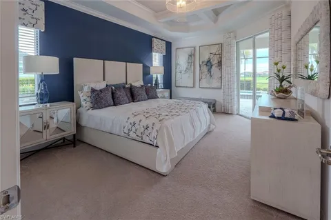 a spacious bedroom with a bed and a large window