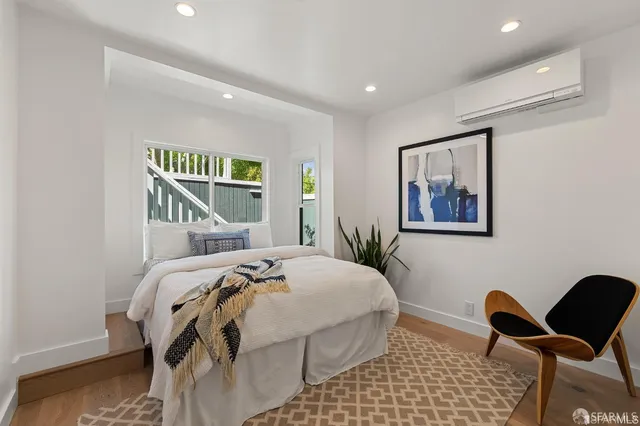 a bedroom with a bed and chair