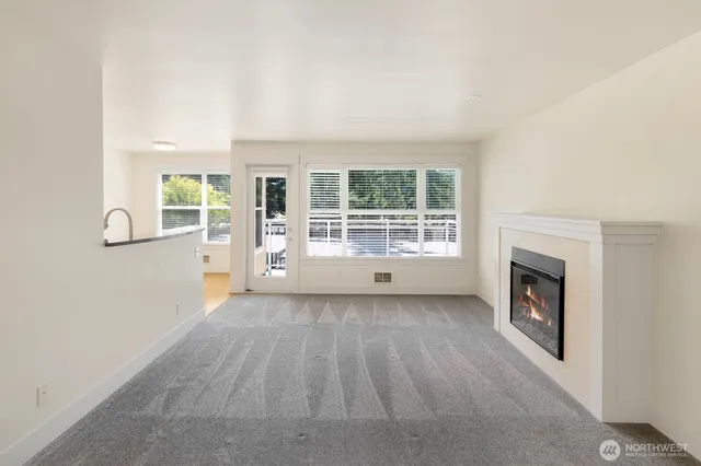 an empty room with furniture and a fireplace