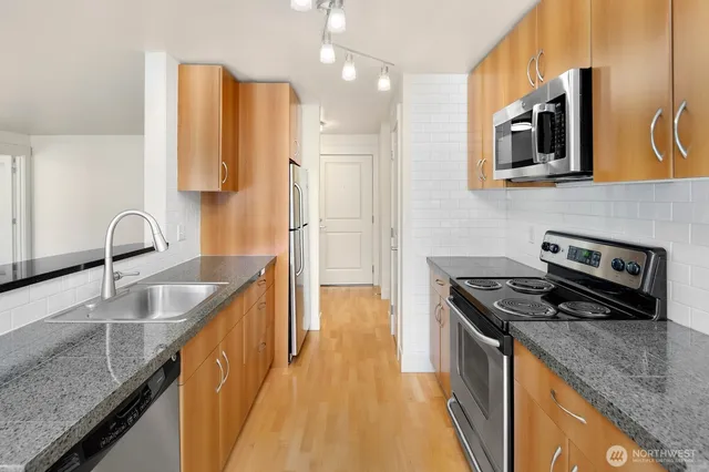 a kitchen that has a sink and a stove