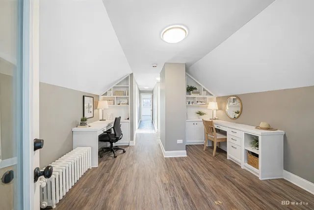 a view of a workspace with furniture and wooden floor