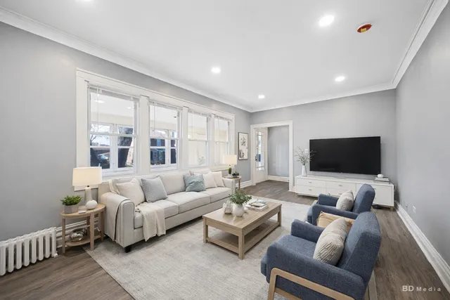 a living room with furniture and a flat screen tv