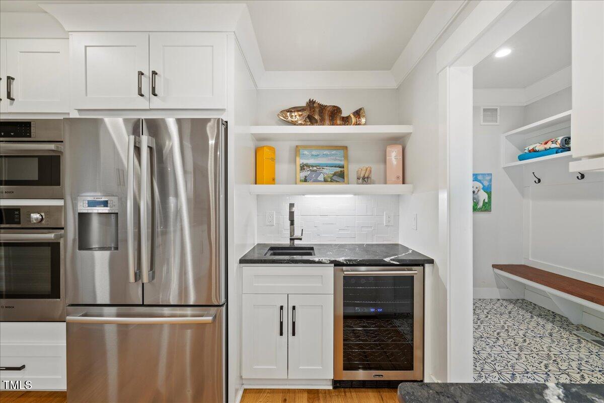 2605 Ridge Road Raleigh, NC 27612 - Photo 14 of 51 a kitchen with stainless steel appliances granite countertop a refrigerator and a stove