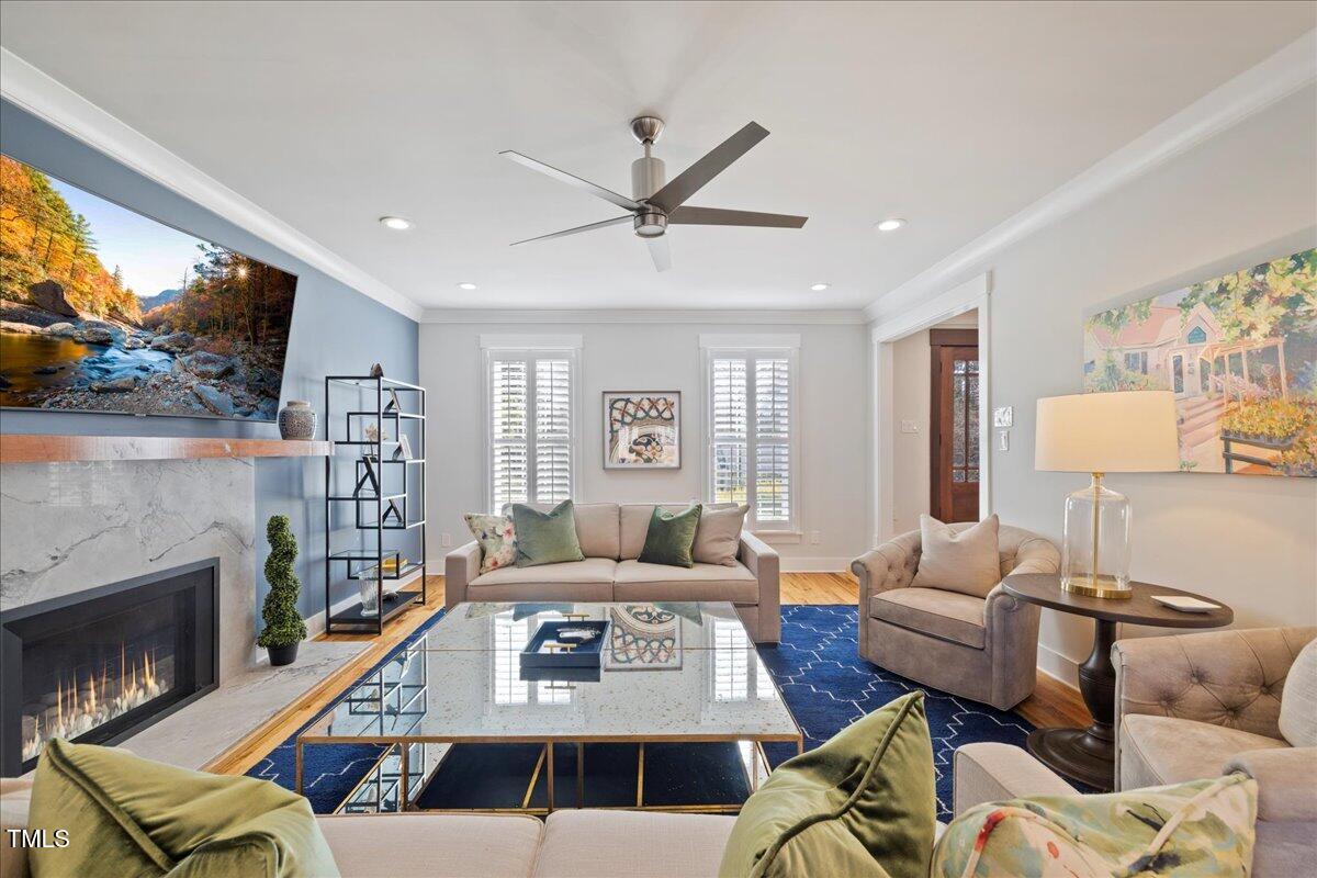 2605 Ridge Road Raleigh, NC 27612 - Photo 16 of 51 a living room with furniture a fireplace and a large window
