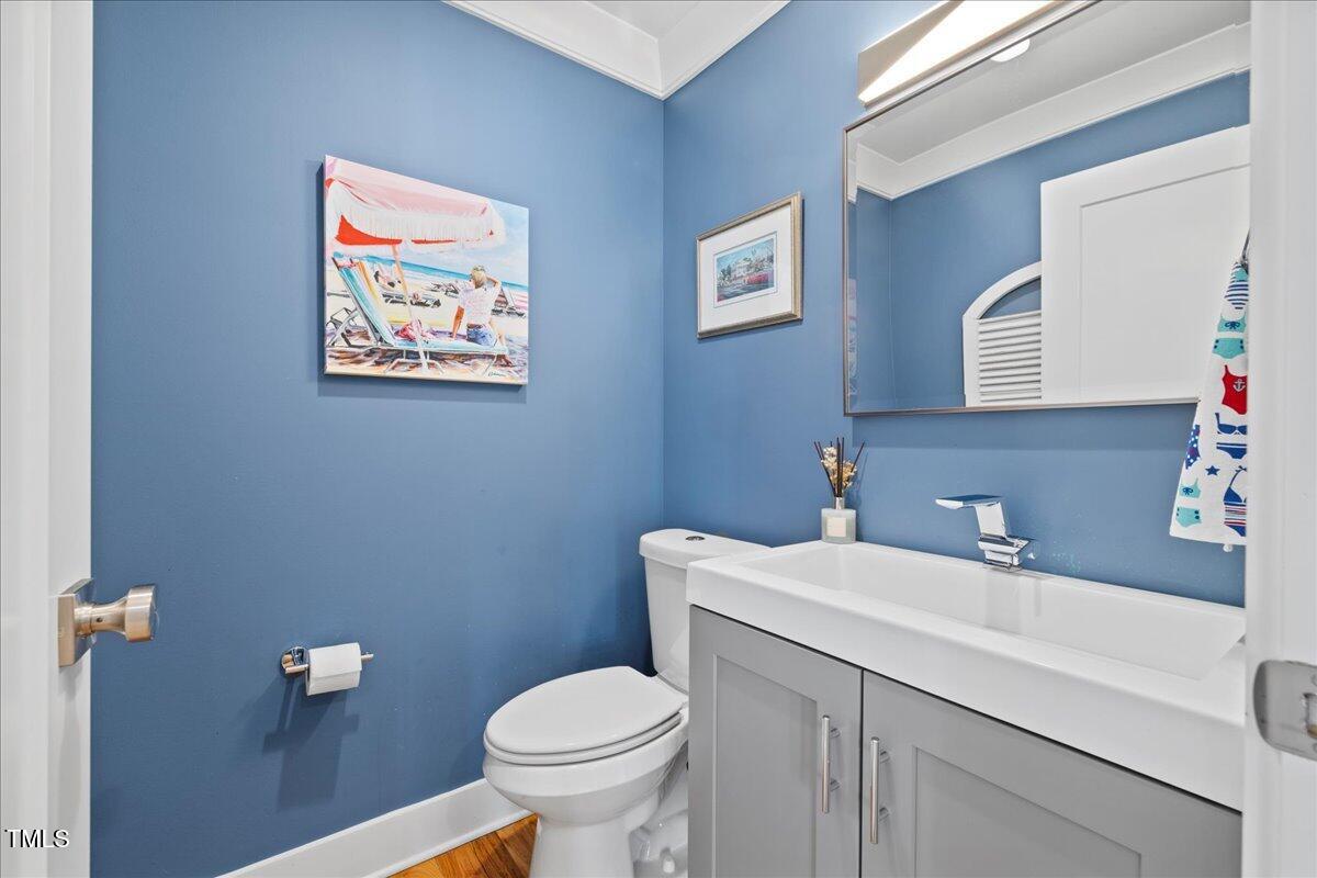 2605 Ridge Road Raleigh, NC 27612 - Photo 20 of 51 a bathroom with a toilet a sink and mirror