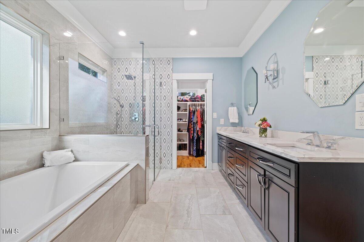2605 Ridge Road Raleigh, NC 27612 - Photo 28 of 51 a bathroom with a granite countertop sink a bathtub and a shower