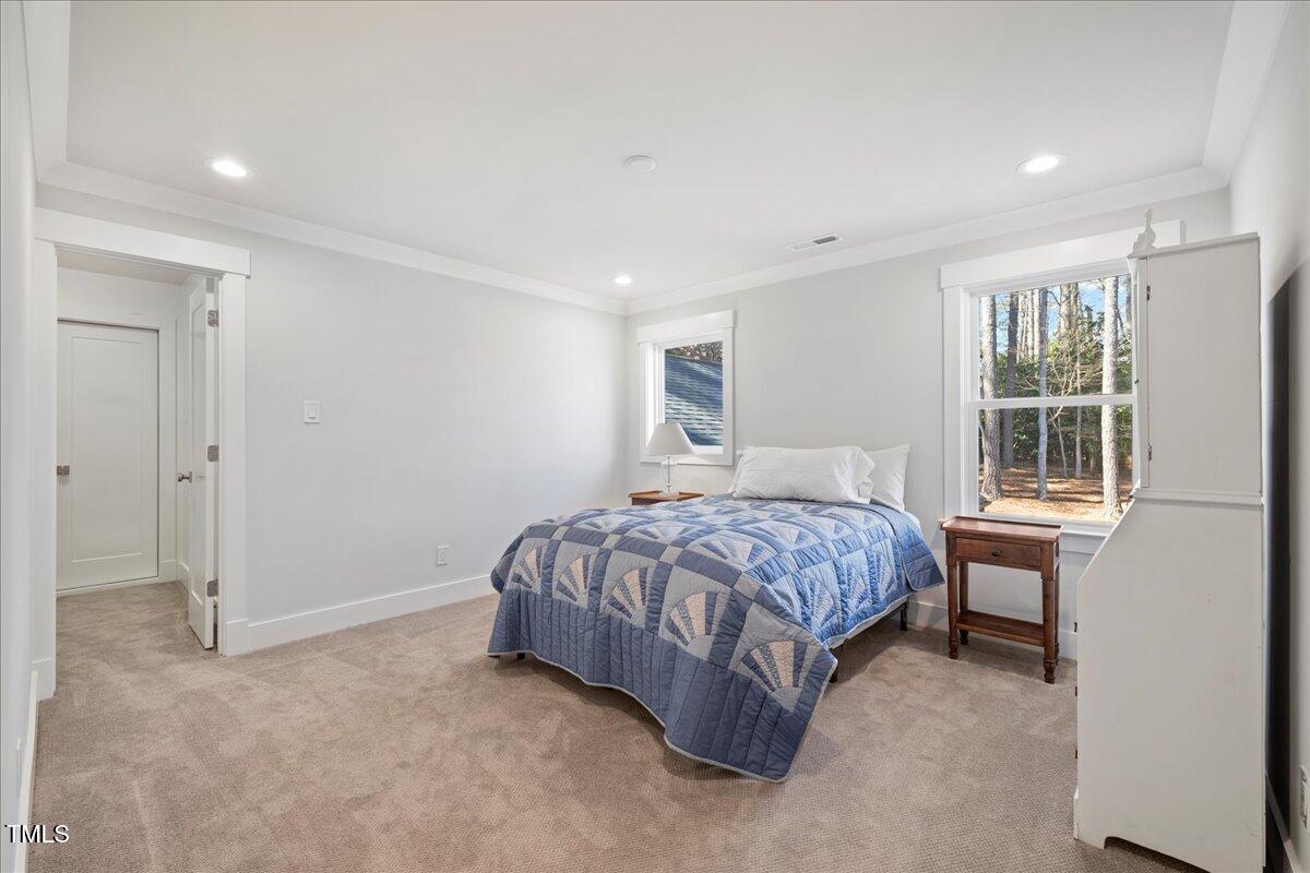 2605 Ridge Road Raleigh, NC 27612 - Photo 38 of 51 a spacious bedroom with a bed and a window