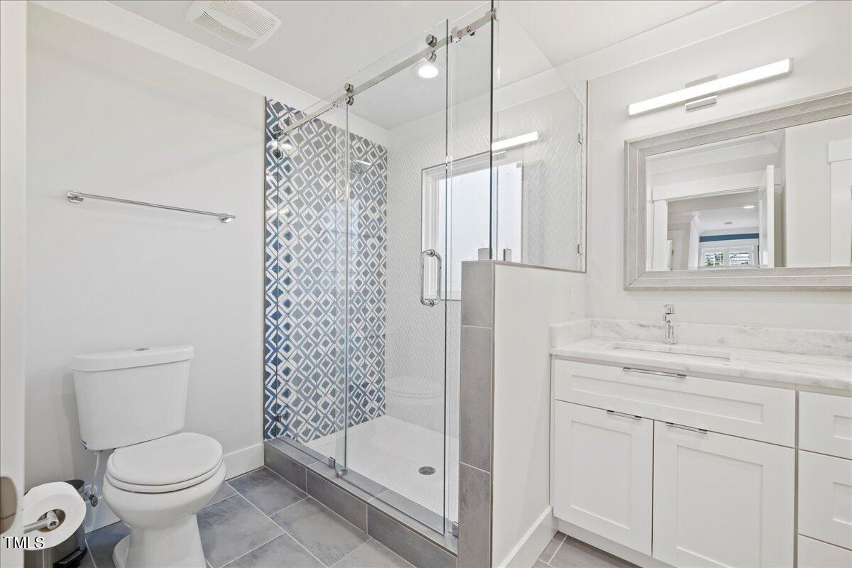 2605 Ridge Road Raleigh, NC 27612 - Photo 42 of 51 a bathroom with a shower toilet sink and mirror