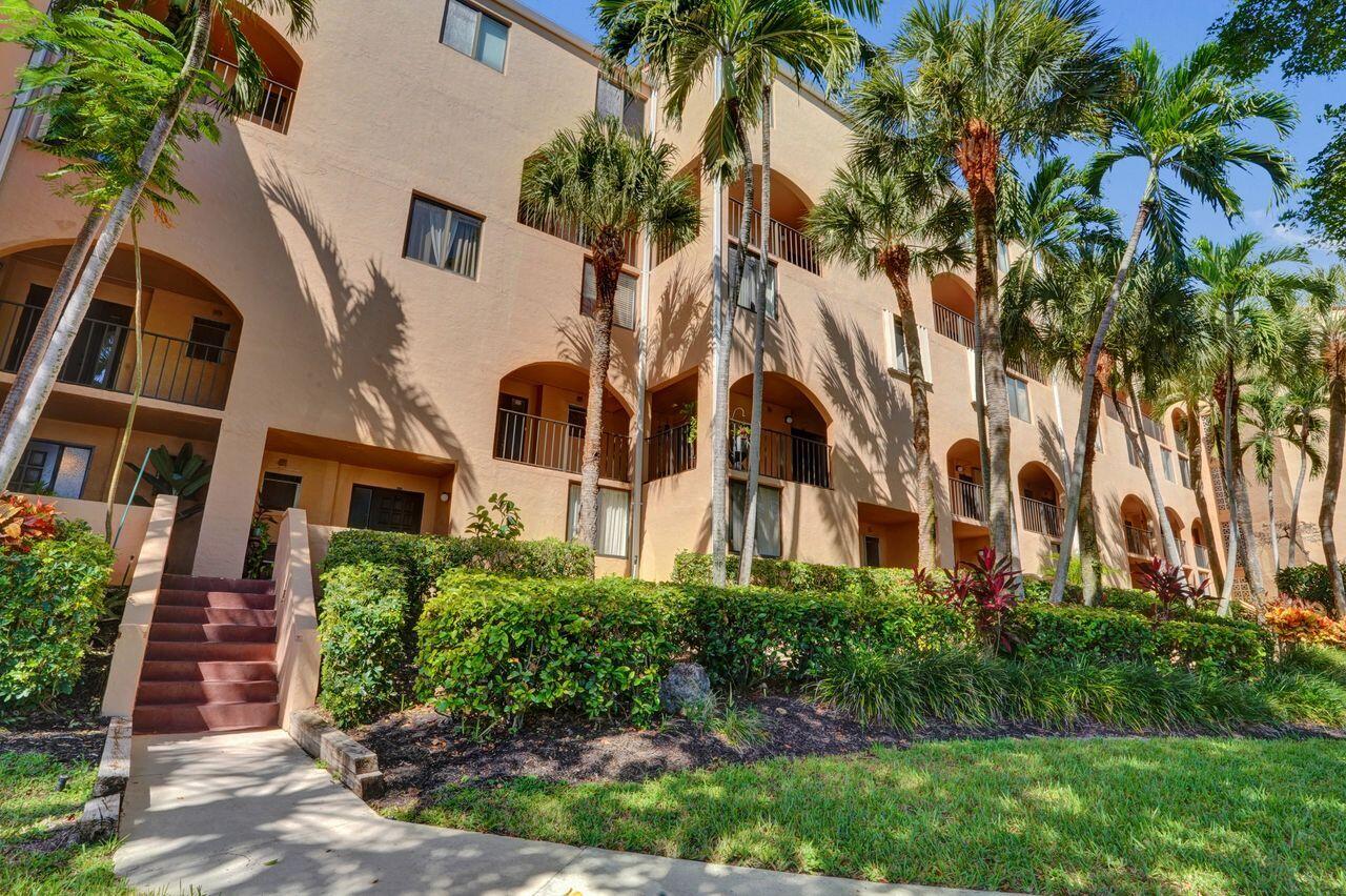 755 Dotterel Road, Unit 1112 Delray Beach, FL 33444 - Photo 42 of 64 a view of a large white building next to a yard