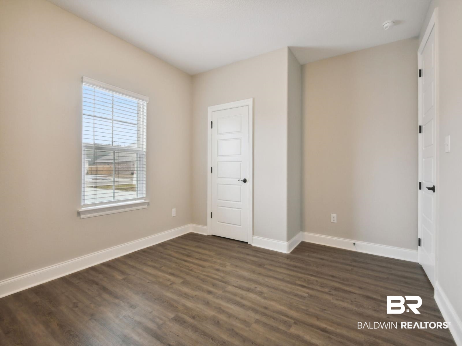 12942 Gondala Street Elberta, AL 36530 - Photo 13 of 18 Unfurnished bedroom with baseboards and dark wood-style flooring