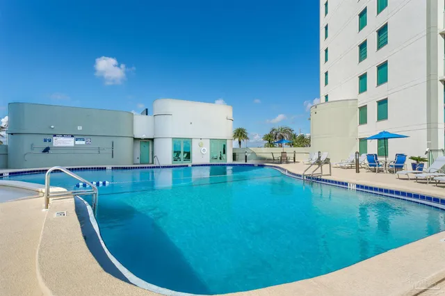 a kitchen with kitchen island sink stove and cabinets