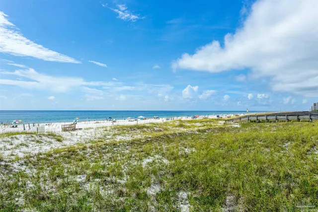 a view of a tennis ground with large buildings