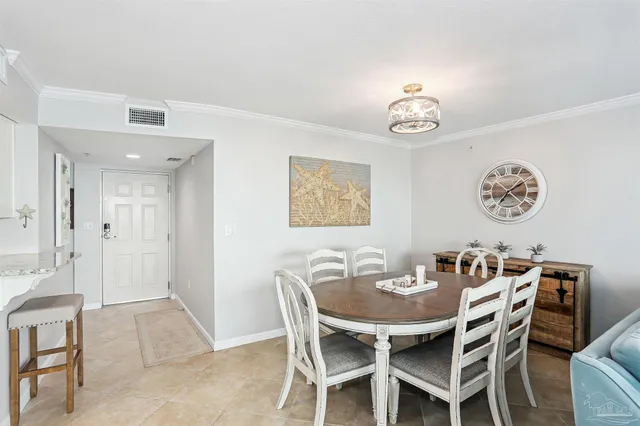a dining room with furniture a flat screen tv and a large window