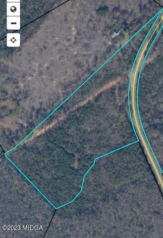 a view of a dry area with wooden fence