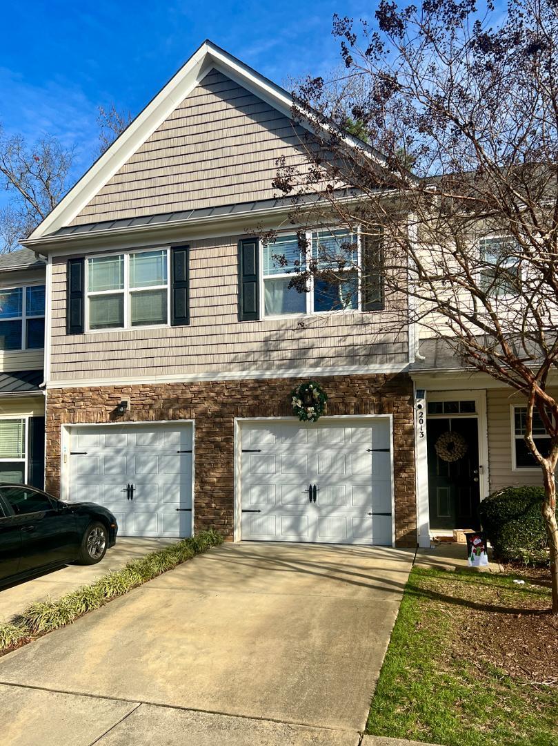 a front view of a house with garage