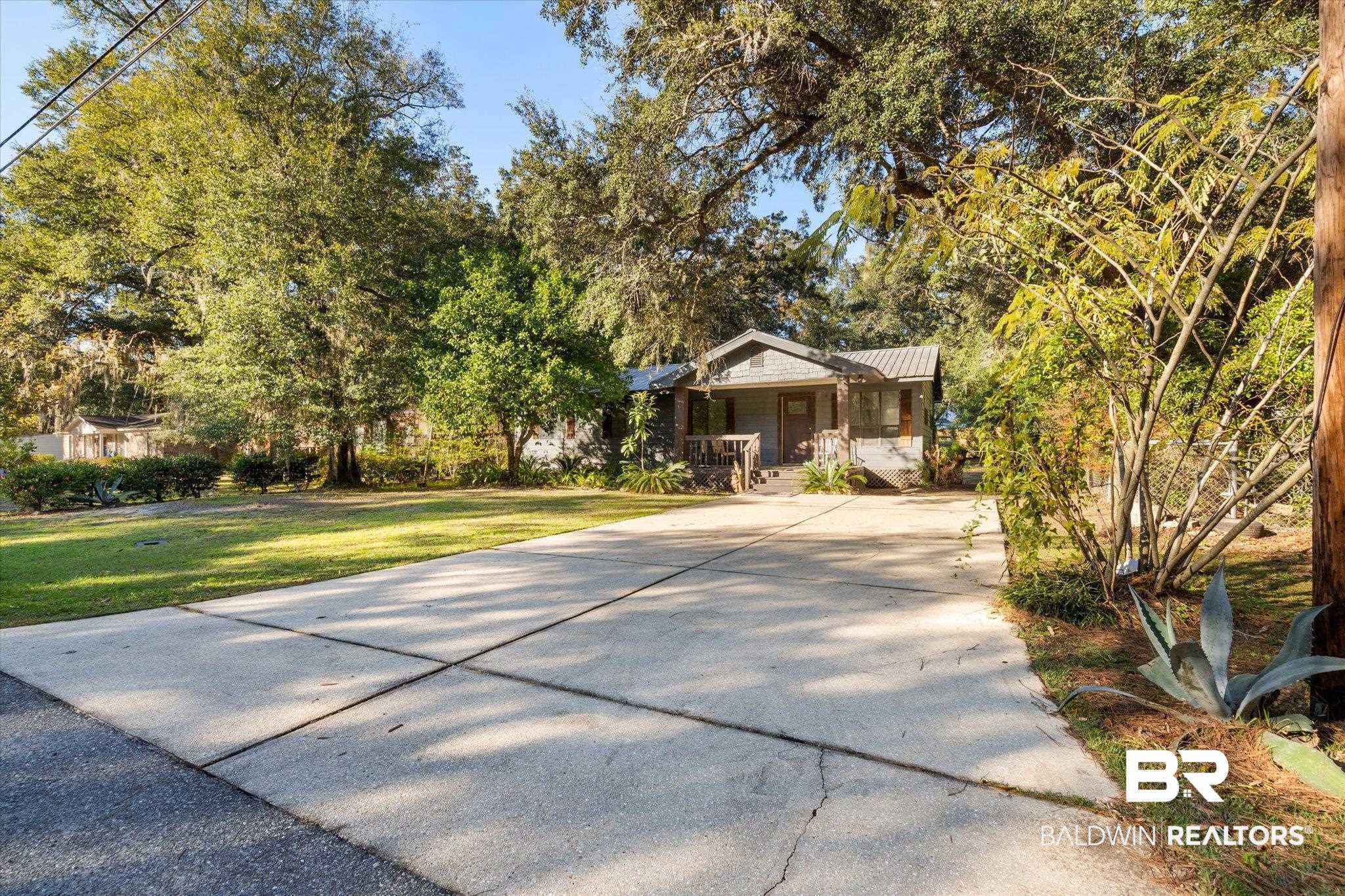 6233 Ponder Road Fairhope, AL 36532 - Photo 20 of 20 View of front of home with a front yard and a porch