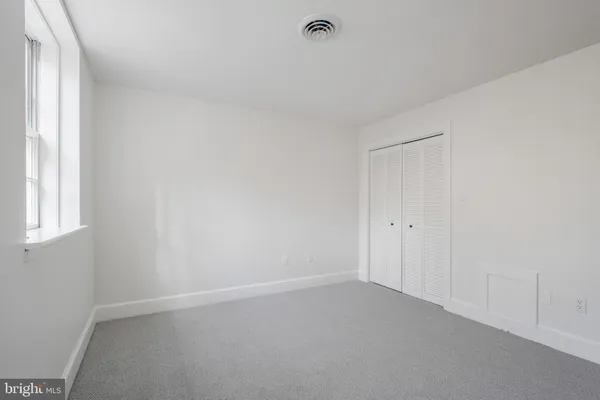 a view of an empty room and a window