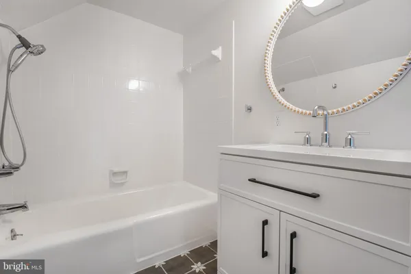 a bathroom with a sink a mirror and a bathtub
