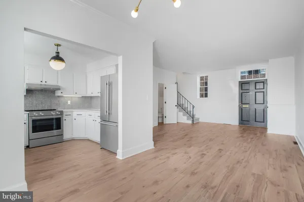 a kitchen with granite countertop a refrigerator stove and oven