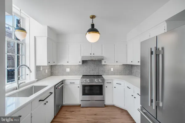 a kitchen with a white cabinets and white appliances