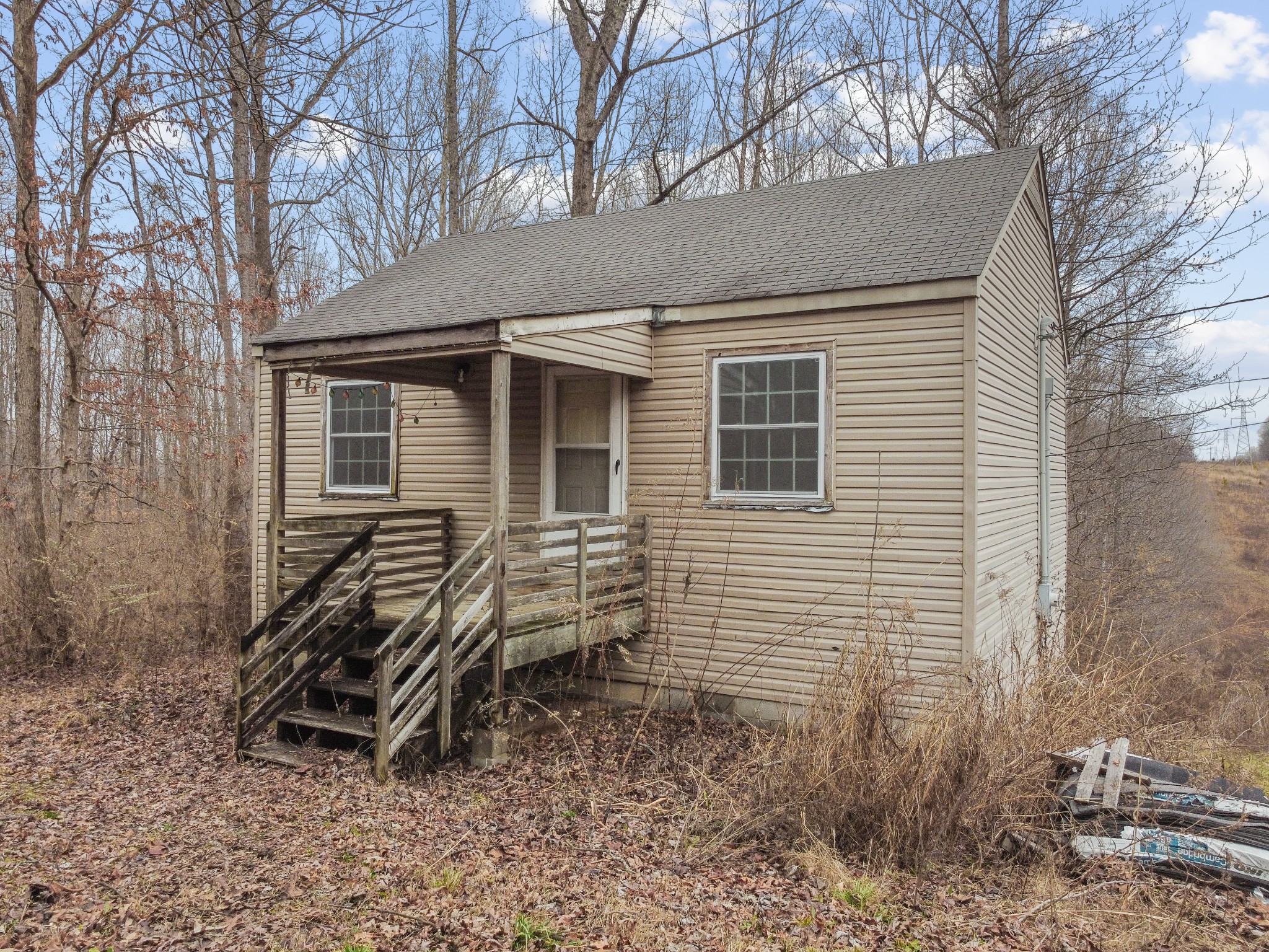 a view of a house with a yard and wooden fence
