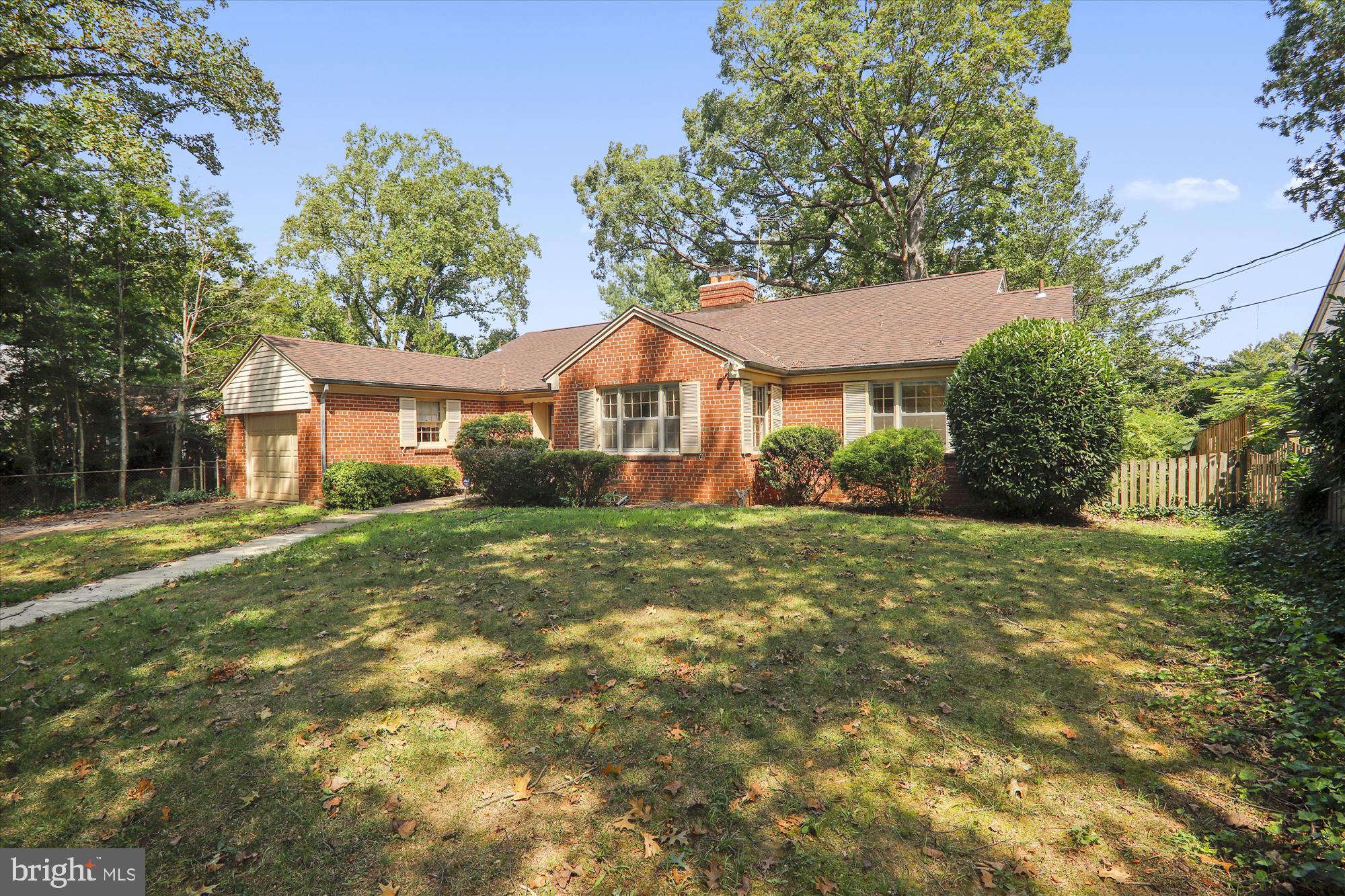 3303 Winnett Road Chevy Chase, MD 20815 - Photo 1 of 54 a view of a yard in front of a house with large trees