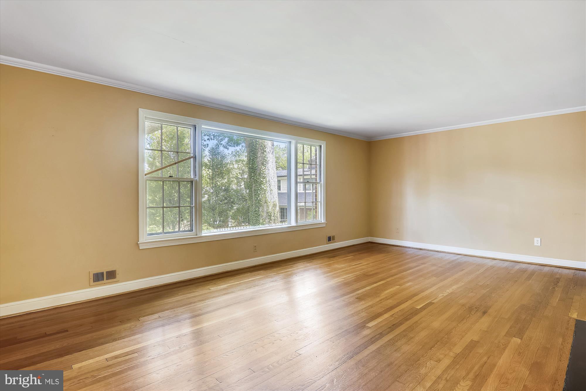 3303 Winnett Road Chevy Chase, MD 20815 - Photo 13 of 54 a view of an empty room with wooden floor and a window