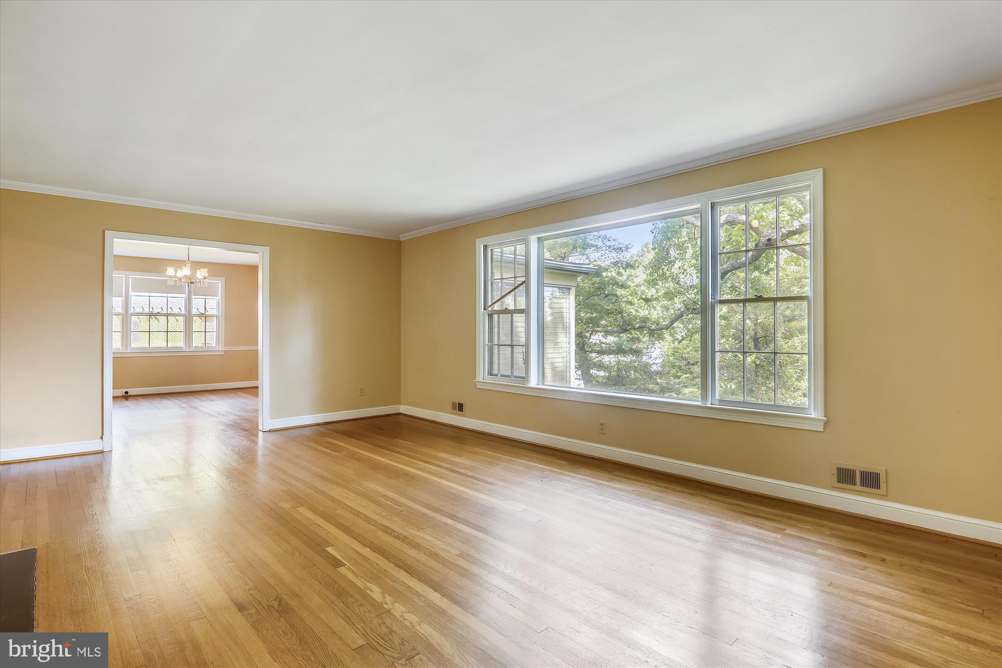 3303 Winnett Road Chevy Chase, MD 20815 - Photo 18 of 54 a view of an empty room with wooden floor and a window