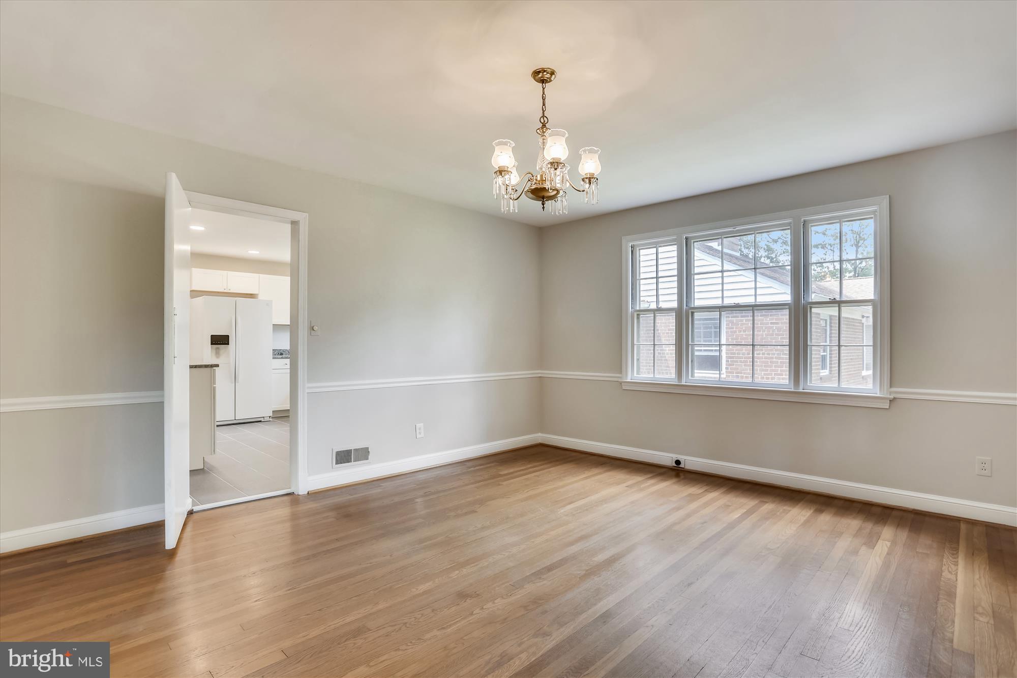 3303 Winnett Road Chevy Chase, MD 20815 - Photo 19 of 54 an empty room with wooden floor and windows