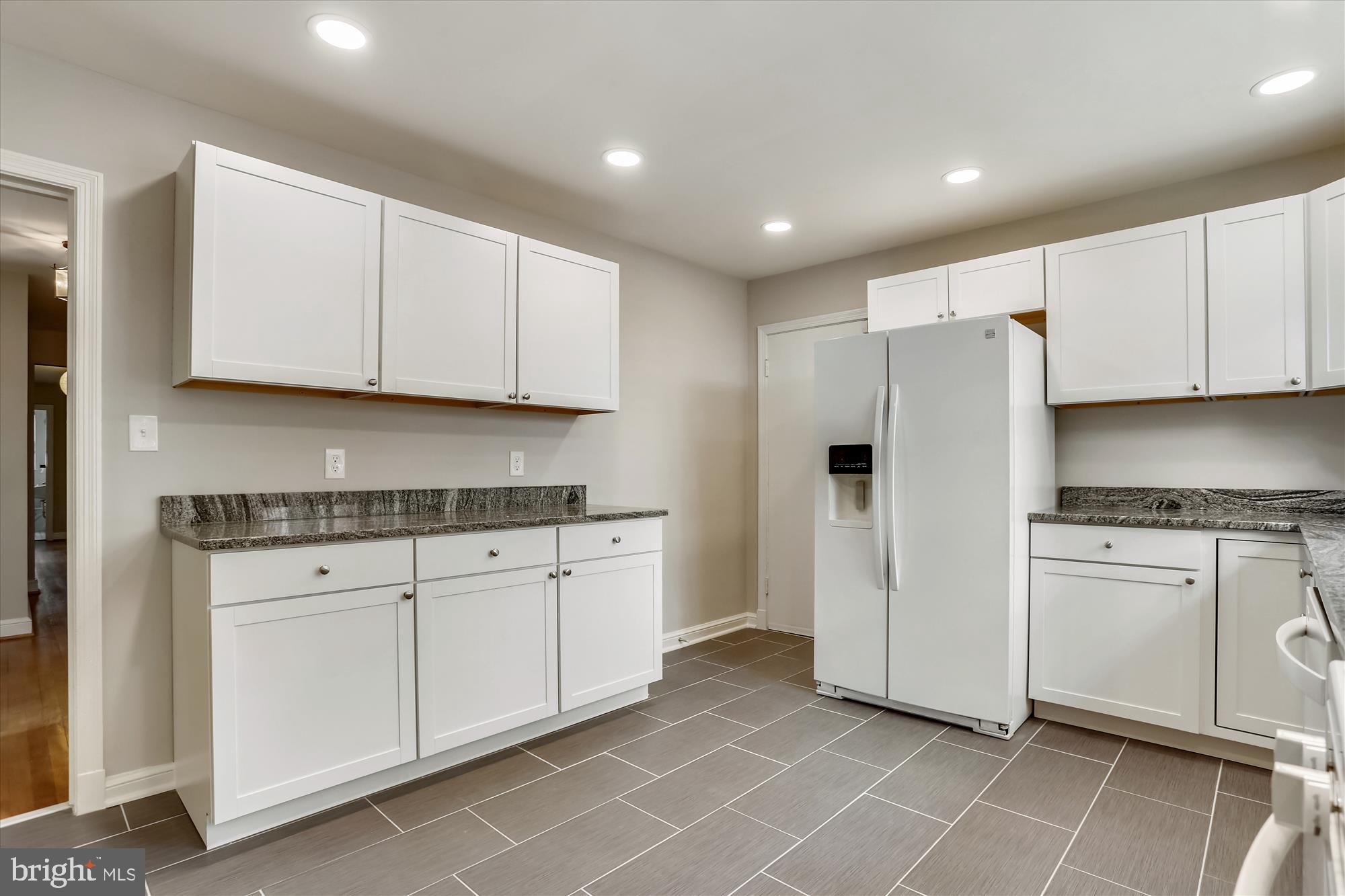 3303 Winnett Road Chevy Chase, MD 20815 - Photo 2 of 54 a kitchen with granite countertop white cabinets white stainless steel appliances with a sink and dishwasher
