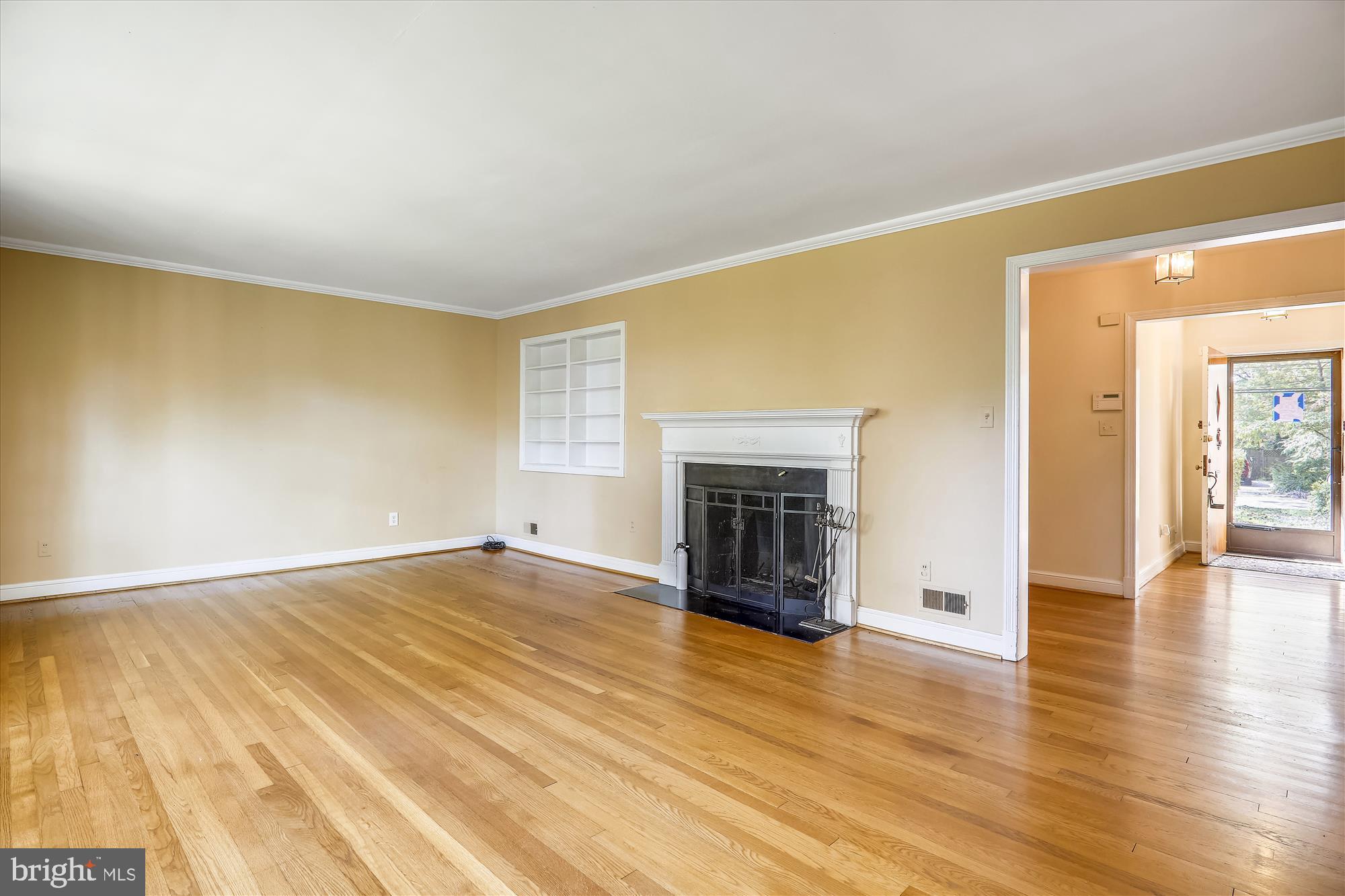 3303 Winnett Road Chevy Chase, MD 20815 - Photo 3 of 54 a view of empty room with wooden floor and fireplace