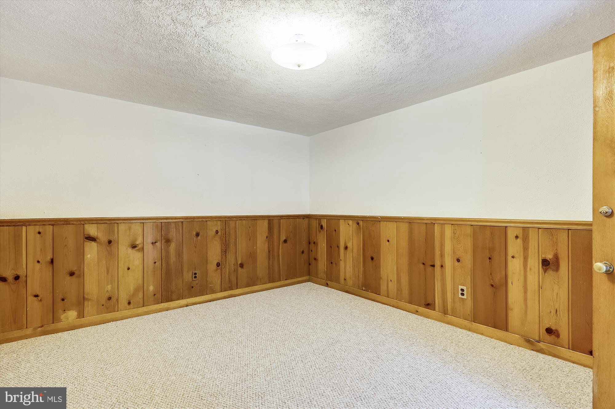 3303 Winnett Road Chevy Chase, MD 20815 - Photo 37 of 54 an empty room with wooden door