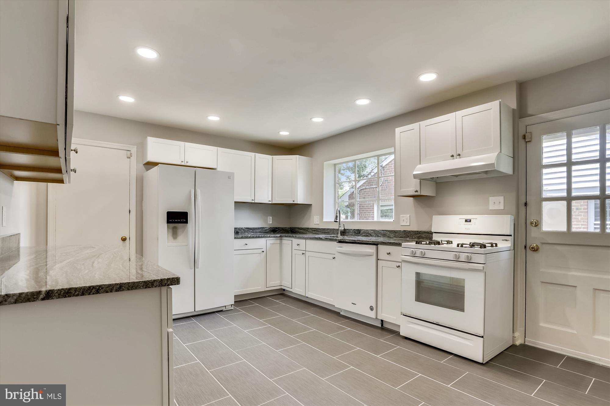 3303 Winnett Road Chevy Chase, MD 20815 - Photo 5 of 54 a kitchen with stainless steel appliances granite countertop a stove a sink and a refrigerator