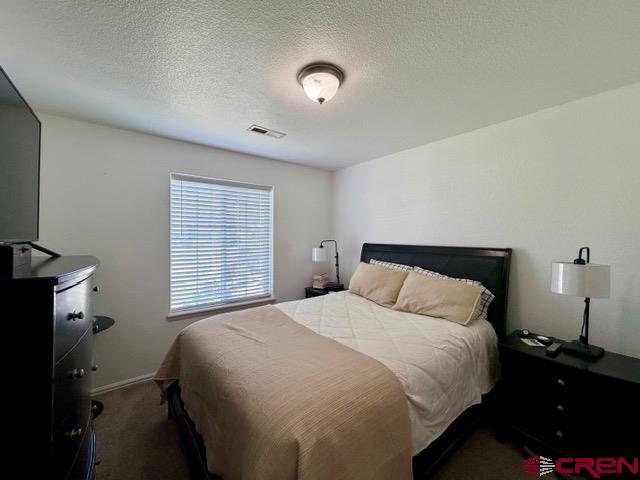544 20th Street Delta, CO 81416 - Photo 28 of 44 a bedroom with a bed and a lamp next to a window