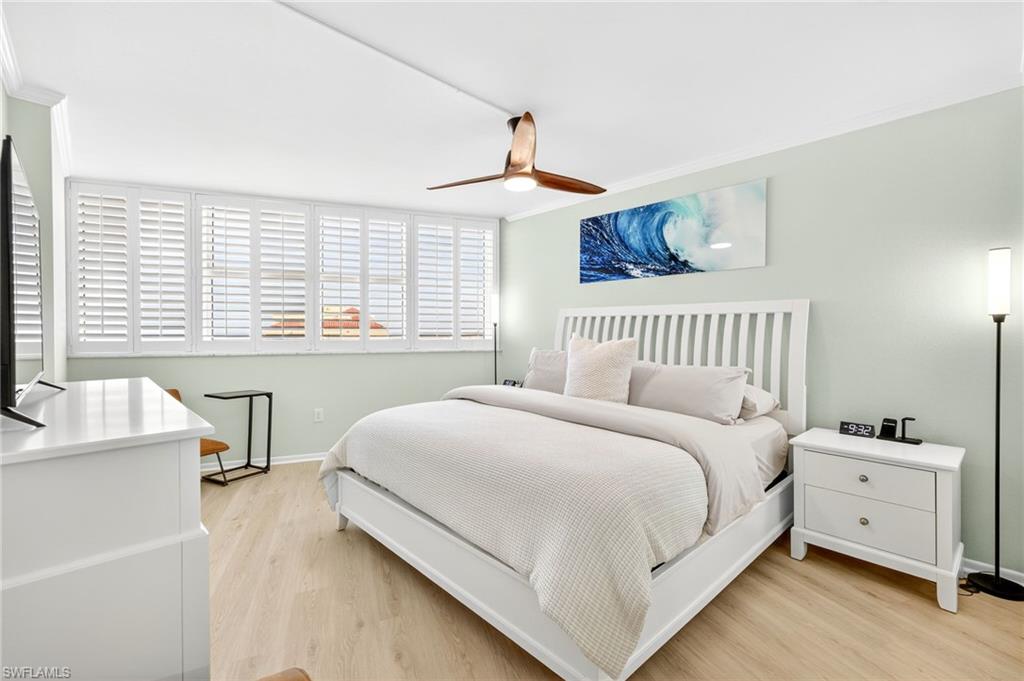 58 North Collier Boulevard, Unit 1606 Marco Island, FL 34145 - Photo 11 of 37 a bedroom with a bed and a window