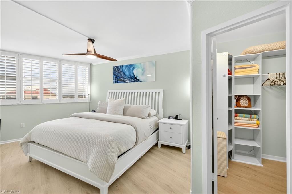 58 North Collier Boulevard, Unit 1606 Marco Island, FL 34145 - Photo 14 of 37 a bedroom with a bed and a window