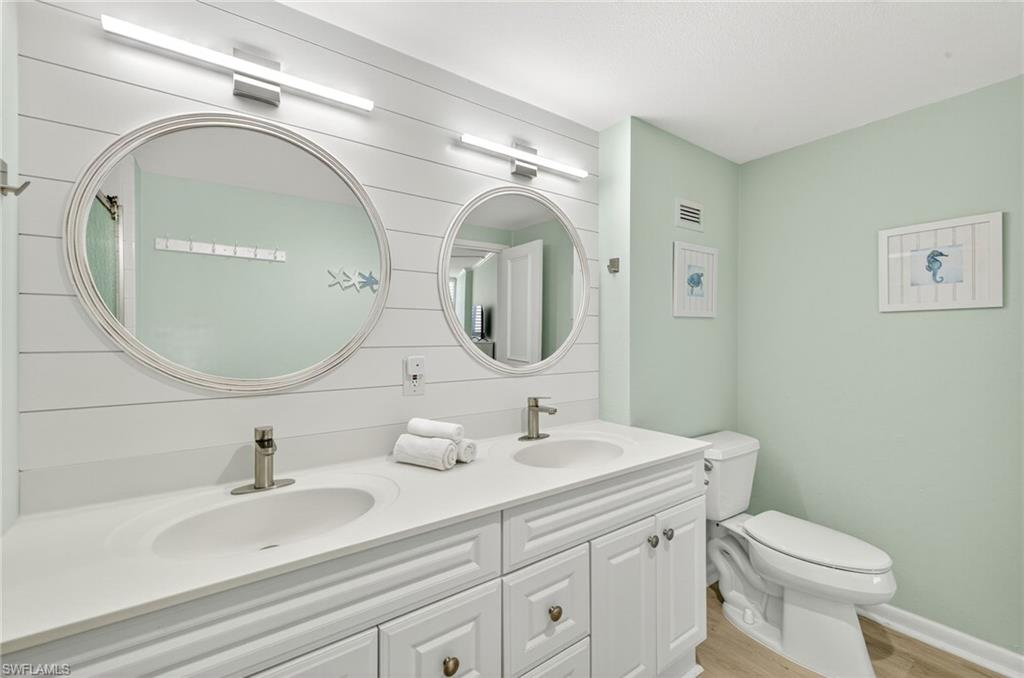 58 North Collier Boulevard, Unit 1606 Marco Island, FL 34145 - Photo 17 of 37 a bathroom with a toilet sink and mirror