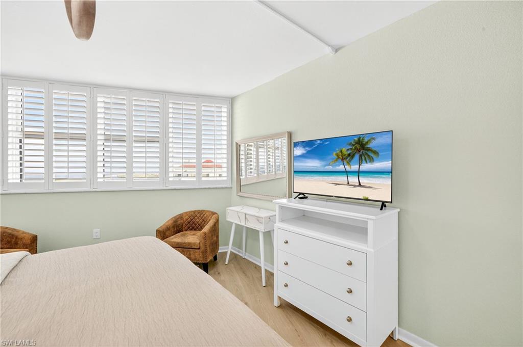 58 North Collier Boulevard, Unit 1606 Marco Island, FL 34145 - Photo 19 of 37 a bedroom with a bed and a window