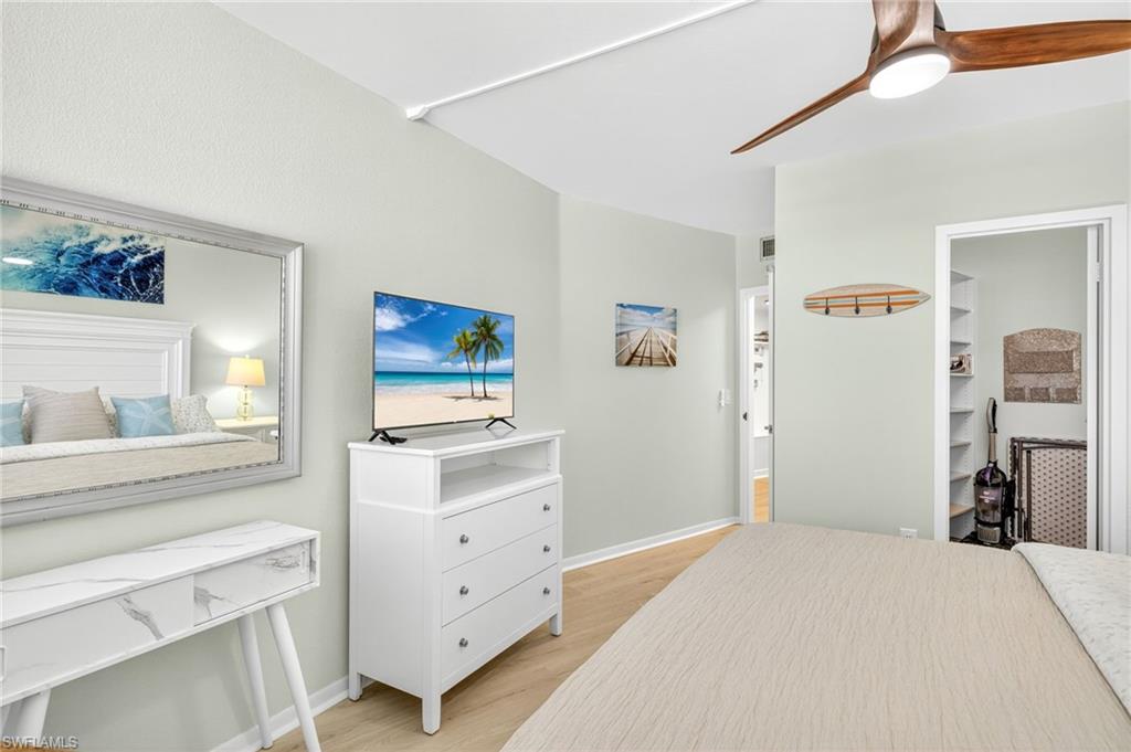 58 North Collier Boulevard, Unit 1606 Marco Island, FL 34145 - Photo 20 of 37 a bedroom with a bed and a dresser in it