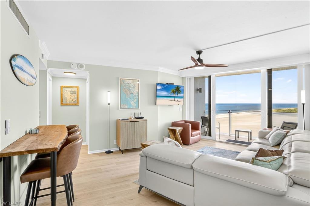 58 North Collier Boulevard, Unit 1606 Marco Island, FL 34145 - Photo 2 of 37 a living room with furniture and a table
